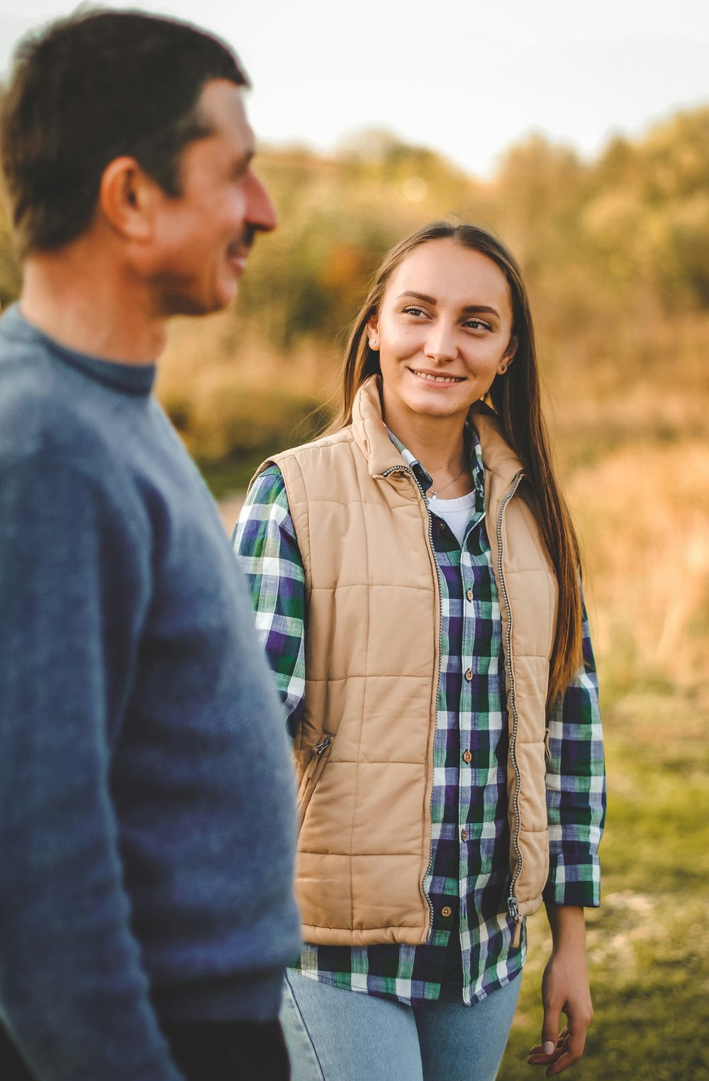 A father and his teenage daughter outdoors
